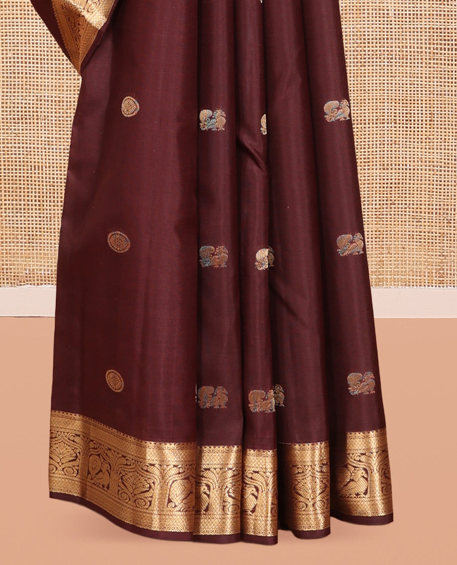 Brown Vasundhara Silk Saree, Enriched with Mayil-Chakram Buttas, a Zari Border of Rekku, Mayil Kann, and Mayil Designs, a Grand Pallu, and a Matching Blouse