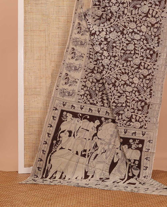 Brown floral vine machine printed kalamkari cotton saree, figurines motifs border, and pallu of pichwai cow, and Lord Kishna motifs