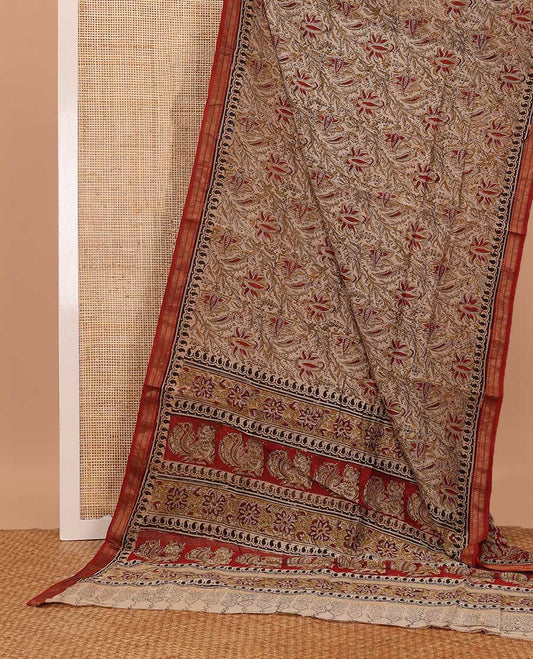 Fawn color floral machine printed kalamkari cotton saree, contrast traditional zari border, and pallu of floral-peacock print