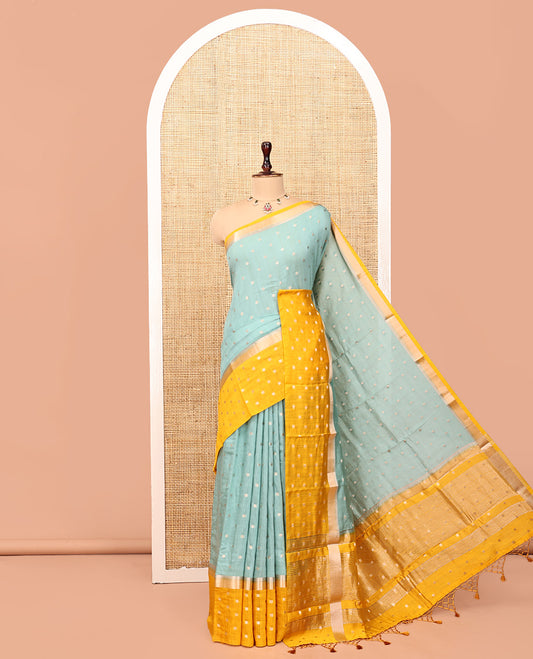 Pale Blue Assam Silk Saree, Steeped with Zari Buttas, Complemented by Contrast Zari Buttas Woven Border, Gleaming Pallu, and Contrast Blouse