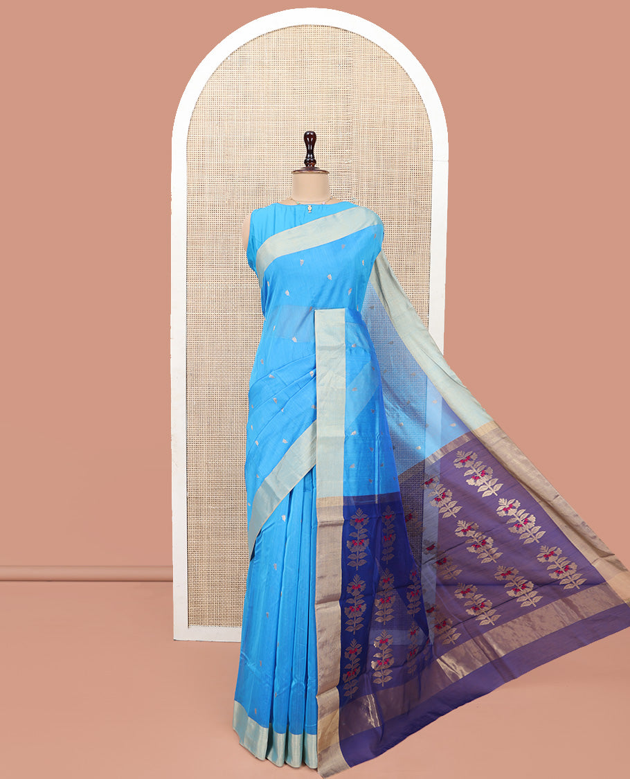 Blue Chanderi Cotton Saree, Subtly Sparkled with Buttas All Over Its Body, Subtly Woven Bavanji Border, Complemented by a Contrast Pallu Steeped with Floral Designs, and Paired with a Contrast Blouse