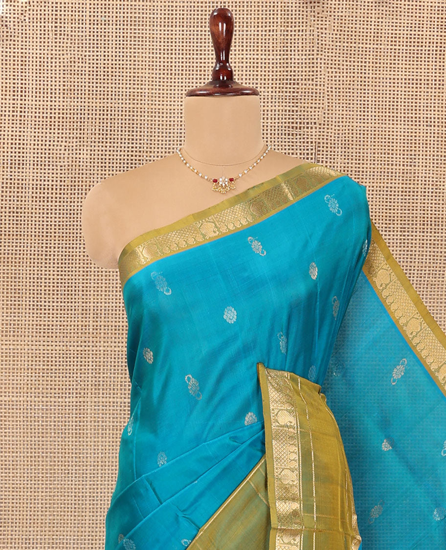 Blue Uppada Silk Saree Graced with Zari Buttas, Complemented by a Contrast Traditional Zari Border of Peacock Veena Designs, Contrast Pallu of Floral Jaal Designs, and Paired with a Contrast Blouse