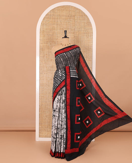 Black vertical stripes printed mul cotton saree, contrast batik printed border, pallu of geometric batik print, and a contrast printed blouse