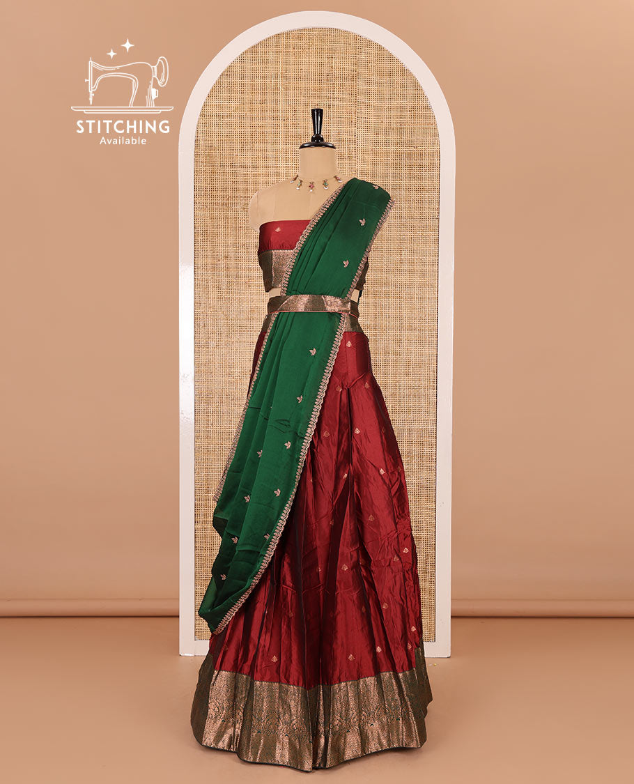 Maroon taffeta silk half-saree, zari buttas with contrast traditional zari bordered skirt, matching zari design blouse, and contrast scallop buttas embroidered dhavani