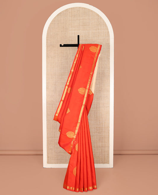 Orange Kanchipuram Silk Saree, Beautified with Zari Buttas All Over Its Body, Subtle Zari Piping Border, Complemented by a Contrast Pallu of Traditional Zari Designs, and Paired with a Contrast Blouse