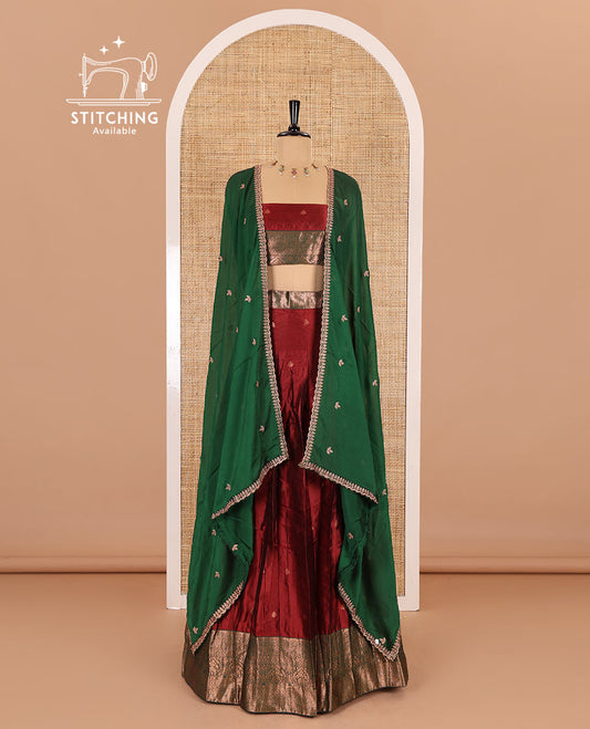 Maroon taffeta silk half-saree, zari buttas with contrast traditional zari bordered skirt, matching zari design blouse, and contrast scallop buttas embroidered dhavani