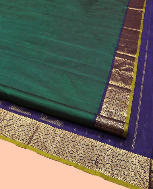 Green Plain Kanchipuram Silk Saree, Complemented by Contrast Border of Thilakam Mokku, and Rudraksham Designs, Pallu of Zari Designs, and Paired with a Contrast Blouse