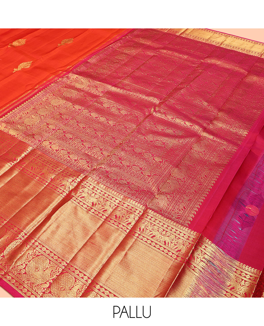 Orange Kanchipuram Silk Saree, Bedecked with Zari Buttas All Over Its Body, Complemented by a Contrast Border of Manga Mokku, Poun, Yaanai, and Mayil Designs, Grand Pallu of Kodi Visiry Designs, and Paired with a Contrast Blouse