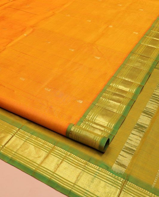 Orange Kanchipuram Silk Saree, Enriched with Zari Buttas on Its Body, Complemented by a Contrast One-Sided Border of Panner Sombu, Banaras, Muthu, and Mayil Kann Designs, Pallu of Zari Designs, and Comes Without a Blouse