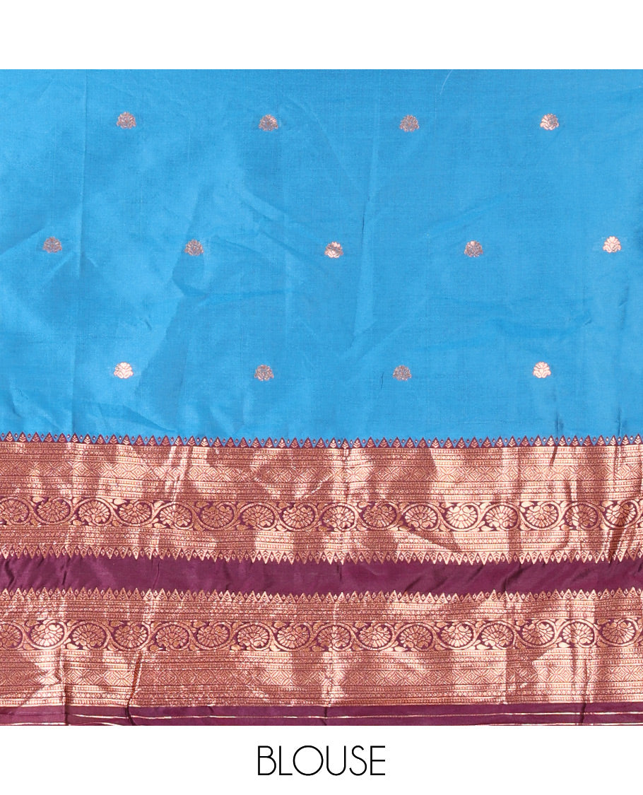 Blue and Purple Semi-Banarasi Half-Saree Featuring Zari Buttas Skirt, Complemented by Contrast Rettai Pettu, Traditional Border of Floral Creeper Designs, Paired with a Matching Blouse, and a Satin Georgette Embroidered Scallop Dhavani