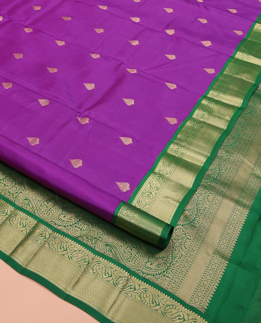 Purple Vasundhara Silk Saree, Ornamented with Zari Buttas All Over Its Body, Complemented by a Contrast Border of Rekku, Muthu, and Kodi Visiry Designs, Grand Pallu Steeped with Manga Designs, and Paired with a Contrast Blouse