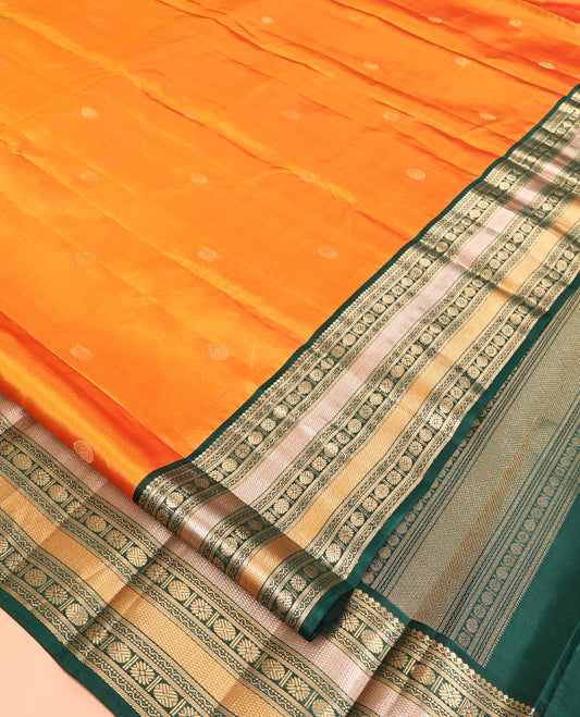 Orange Vasundhara Silk Saree, Woven with Zari Buttas, Contrast Border of Thilakam Mokku, Neli, Muthu, Kuyil Kann, Rudraksham, and Star Vanki, Grand Pallu, and a Contrast Blouse