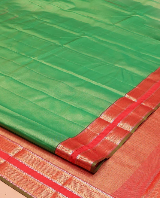 Green Vasundhara Lite Silk Mix Saree, Delicately Woven with Zari Stripes on Its Body, Complemented by a Contrast Rettai Pettu Border of Ara Bogudi, Paisa, Banaras, and Ara Maadam Designs, a Grand Pallu, and Paired with a Contrast Blouse