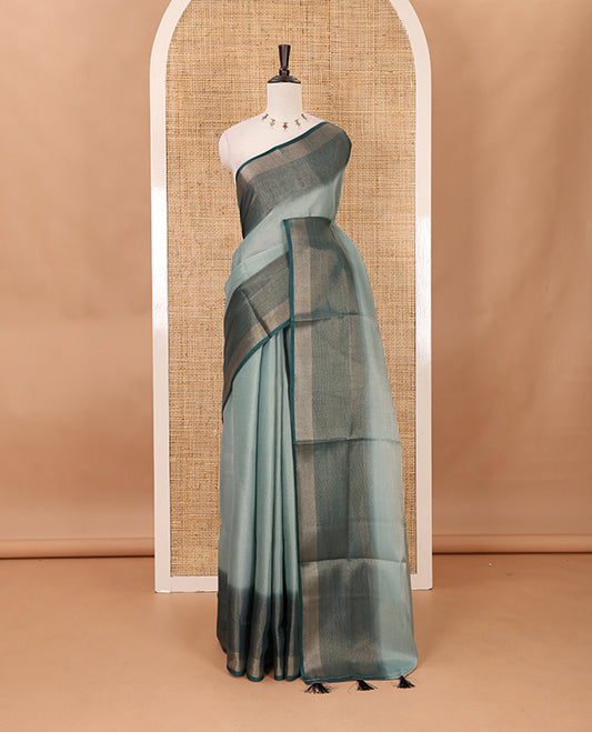 Green plain tissue saree, contrast gold zari piping border & self pallu with tussels