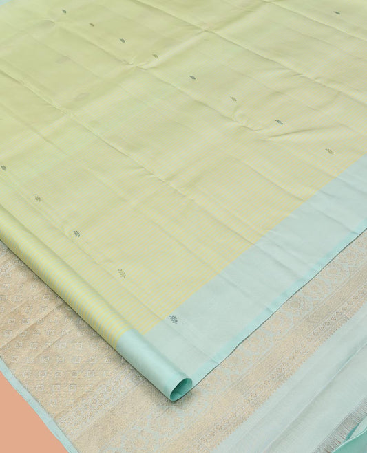 Green Kanchipuram Silk Saree, Subtly Sparkled with Stripes and Thread Buttas, Complemented by a Contrast Border, Jaal Pallu, and Contrast Blouse