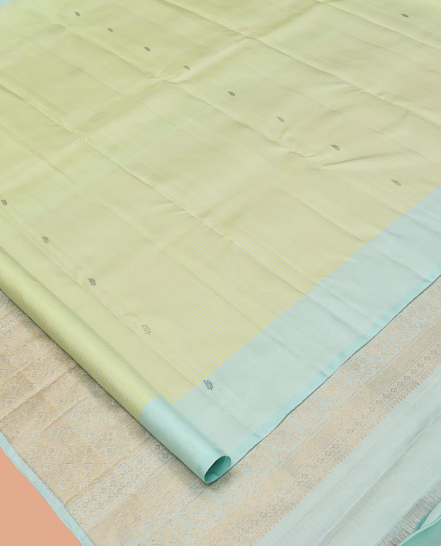 Green Kanchipuram Silk Saree, Subtly Sparkled with Stripes and Thread Buttas, Complemented by a Contrast Border, Jaal Pallu, and Contrast Blouse