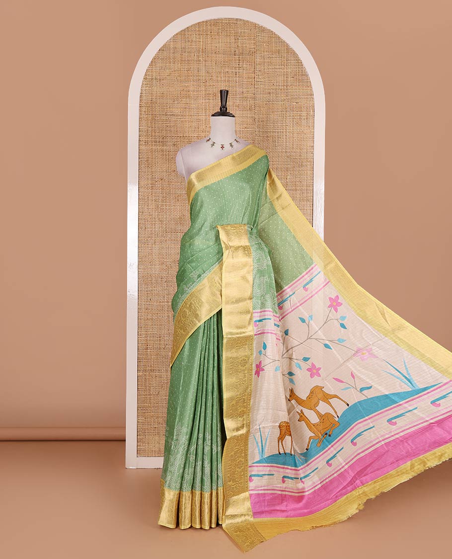Green bandhani dotted trees, and deer motifs printed dola silk saree, contrast zari border, pallu of tree, and deer print, and contrast zari design blouse