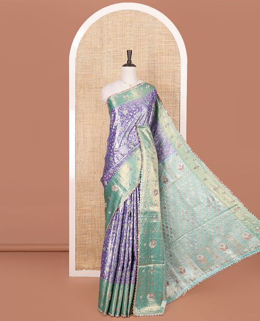 Lavender Vastrakala Silk Saree, Prettified with Floral Jaal and Stone Work, Complemented by Contrast Traditional Zari and Stone Embroidered Scallop Border, Gleaming Grand Stone Work Pallu, and Paired with Contrast Heavy Stone Embroidered Blouse