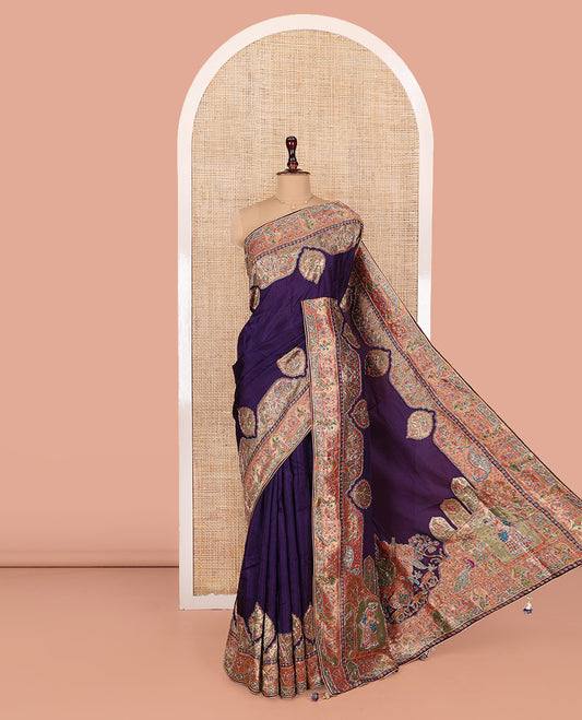 Violet Dola Silk Saree, Uniquely Detailed with Patch Embroidery on Its Body, Highlighted by a Patch Embroidered Border, Pallu Depicts Flora, Fauna, and Human Design Embroidery, and Paired with a Matching Blouse