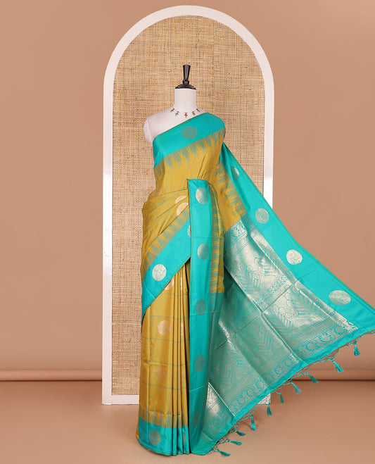 Green round peacock chakram buttas enclosed checked Mulberry silk saree, contrast round peacock chakra border, zari worven pallu, and contrast zari blouse
