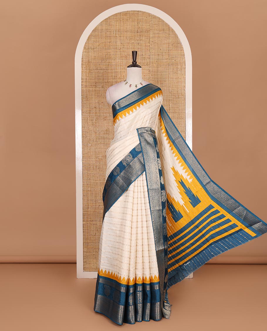 Half-white zari designs dola silk saree, contrast blue temple traditional border of peacock and elephant motifs, and temple pallu