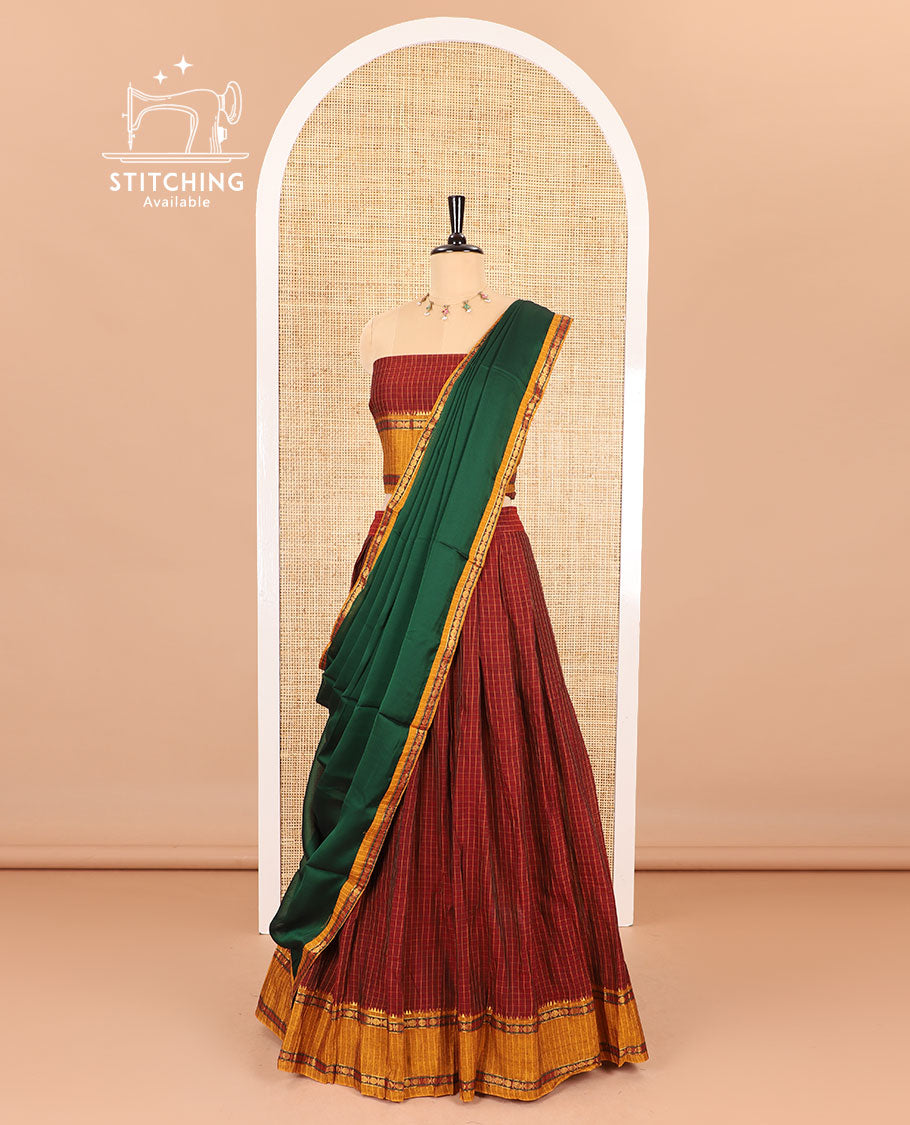 Red half-saree, checked with contrast traditional motifs zari bordered skirt, matching blouse and a contrast zari border plain dhavani