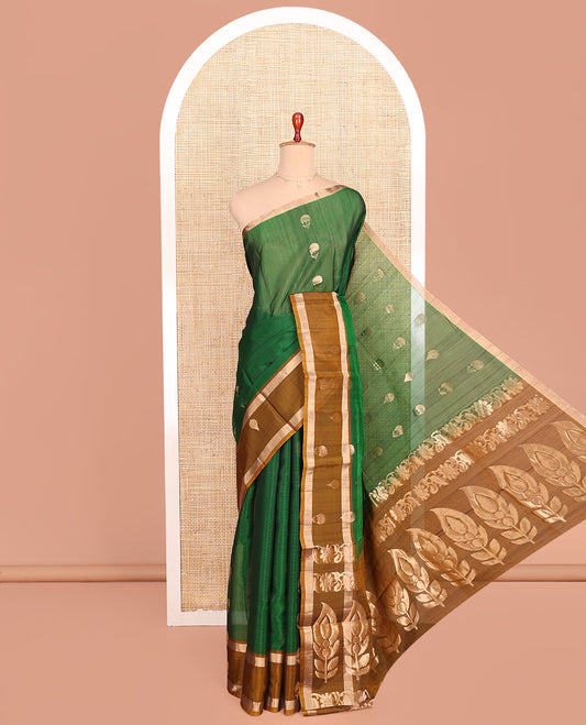 Green Silk Cotton Saree, Spotlighted with Floral Zari Buttas All Over Its Body, Complemented by a Contrast Zari Design Border, Pallu Features Floral and Paisley Designs, and Paired with a Contrast Blouse