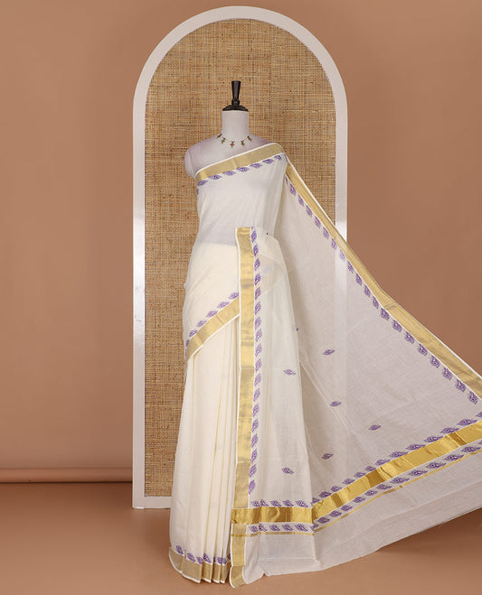 Half-white peacock feather motifs printed Kerala cotton saree, gold zari border, peacock feather printed pallu, and matching blouse