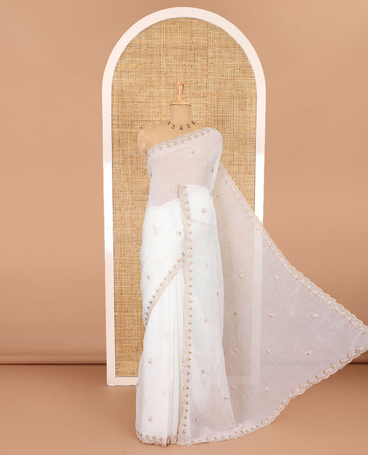 Half-white color, floral embroidered motifs crunchy crush saree, scallop pearl embroidered border,  embroidered pallu, and a contrast embroidered blouse