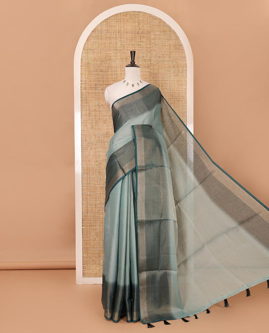 Green plain tissue saree, contrast gold zari piping border & self pallu with tussels
