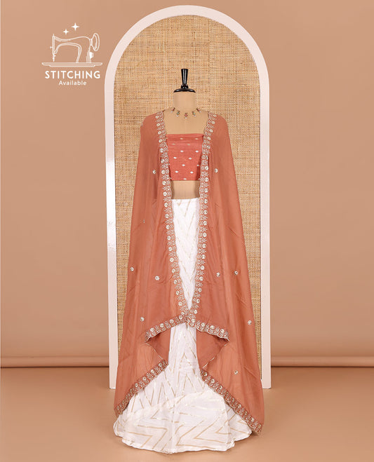 Cream-rust half-saree, gold chevron striped nylon viscose crepe skirt, contrast diamond buttas blouse, and  a contrast scallop floral-theme embroidered dhavani