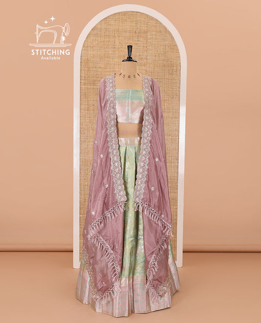 Pale green banarasi half-saree, floral jaal thread weave with contrast floral thread bordered skirt, a matching blouse, and scallop embroidered dhavani with belt