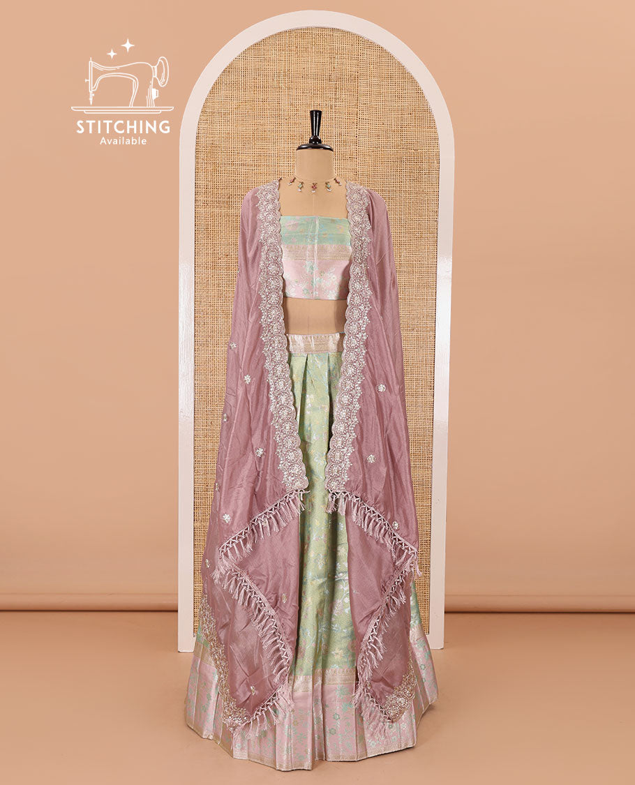 Pale green banarasi half-saree, floral jaal thread weave with contrast floral thread bordered skirt, a matching blouse, and scallop embroidered dhavani with belt