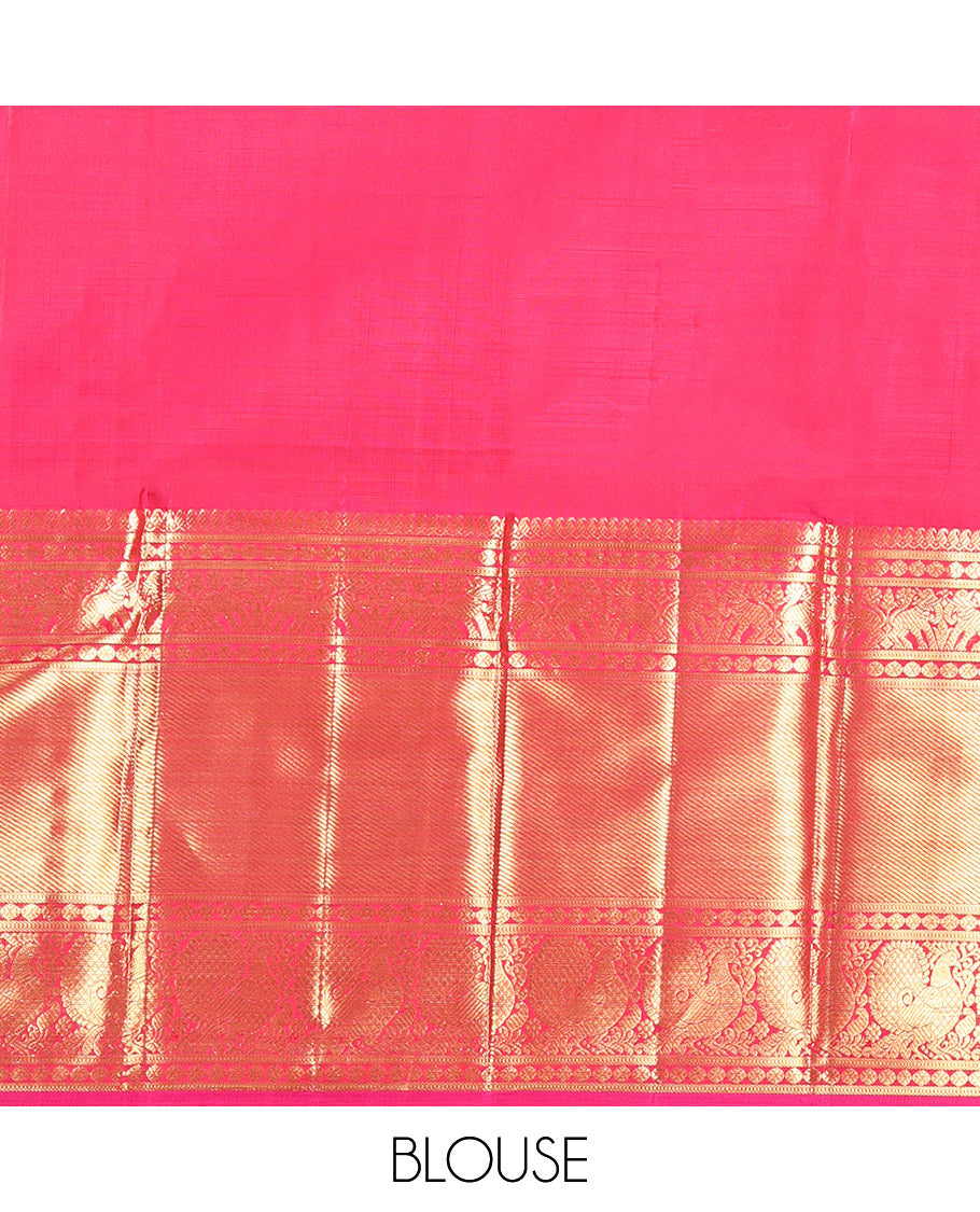 Orange Kanchipuram Silk Saree, Bedecked with Zari Buttas All Over Its Body, Complemented by a Contrast Border of Manga Mokku, Poun, Yaanai, and Mayil Designs, Grand Pallu of Kodi Visiry Designs, and Paired with a Contrast Blouse