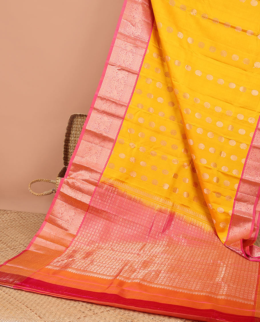 Yellow paisley kancheepuram silk saree with contrast border of sombu, muthu, paun, mayil design & zari design pallu