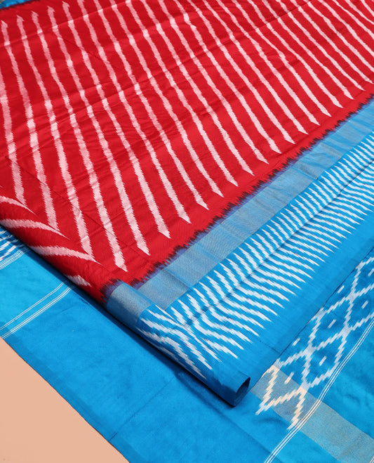 Red Pochampally Ikat Silk Saree, Delicately Woven with Stripes on Its Body, Complemented by a Contrast Border of Stripes, Pallu of Butta Enclosed Jaal Designs, and Paired with a Contrast Blouse