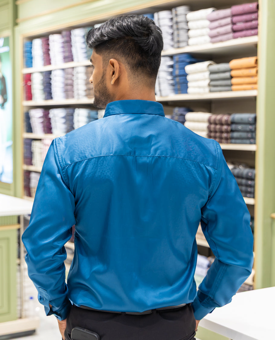 Peacock Blue Poly Satin Party Wear Shirt Features Micro-Stonework, Full Sleeves, a Slim Fit, a Spread Collar, and Regular Length