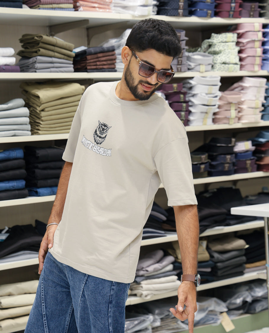 Cream Cotton-Blended T-shirt Features Funky and Bold Motifs Print, Half-Sleeves, Oversized Fit, Round Neck, and Regular Length