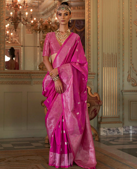 Rani Pink Designer Catalog Saree Adorned with Square Buttas All Over Its Body, Highlighted with a Zari Border of Maze-Like Geometric Patterns, Pallu Mirrors Intricate Maze patterns in Zari, and Paired with a Matching Blouse