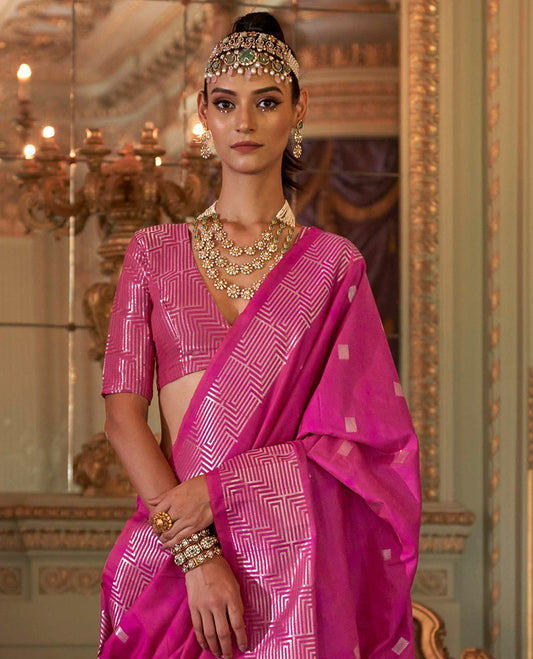 Rani Pink Designer Catalog Saree Adorned with Square Buttas All Over Its Body, Highlighted with a Zari Border of Maze-Like Geometric Patterns, Pallu Mirrors Intricate Maze patterns in Zari, and Paired with a Matching Blouse