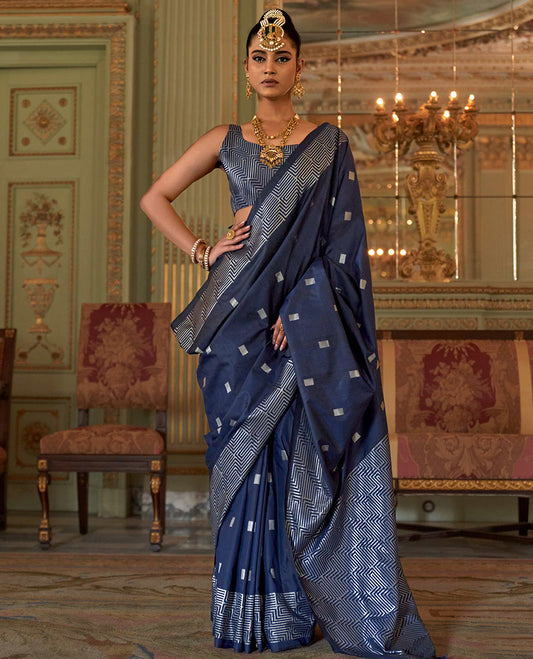 Blue Designer Catalog Saree Elevated with Square Buttas All Over Its Body, Highlighted with a Zari Border of Maze-Like Geometric Patterns, Pallu Mirrors Intricate Maze patterns in Zari, and Paired with a Matching Blouse