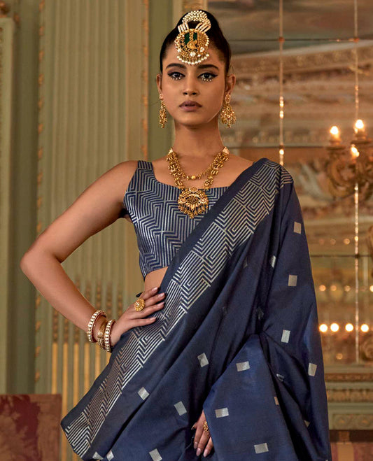 Blue Designer Catalog Saree Elevated with Square Buttas All Over Its Body, Highlighted with a Zari Border of Maze-Like Geometric Patterns, Pallu Mirrors Intricate Maze patterns in Zari, and Paired with a Matching Blouse