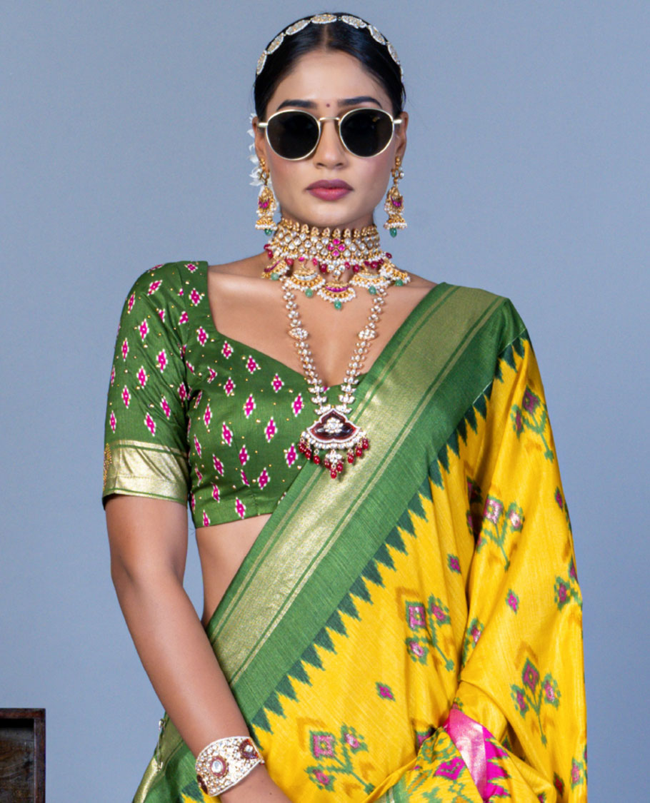 Yellow patola floral motifs designer saree, contrast temple border, and patola printed pallu