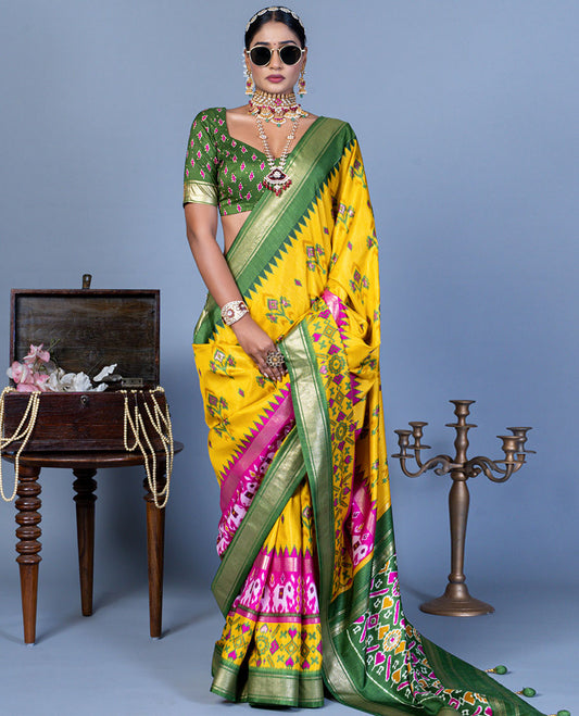 Yellow patola floral motifs designer saree, contrast temple border, and patola printed pallu