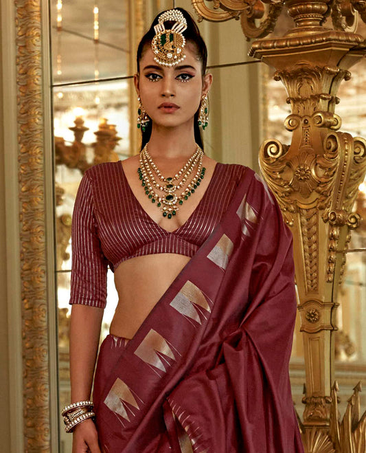 Maroon Plain Designer Saree, Complemented by a Gleaming Temple Zari Border, Scintillating Zari Decked Up Pallu, and Comes with a Matching Blouse