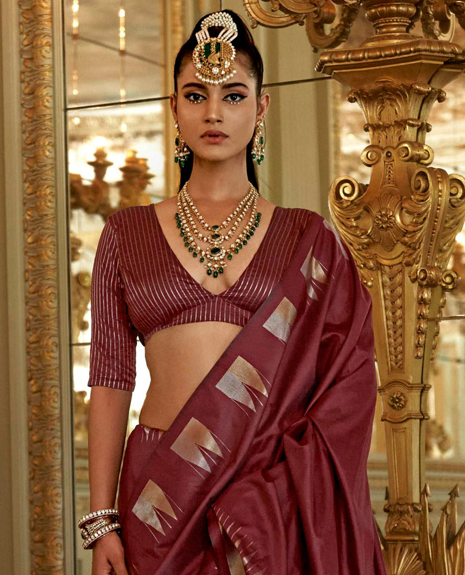 Maroon Plain Designer Saree, Complemented by a Gleaming Temple Zari Border, Scintillating Zari Decked Up Pallu, and Comes with a Matching Blouse