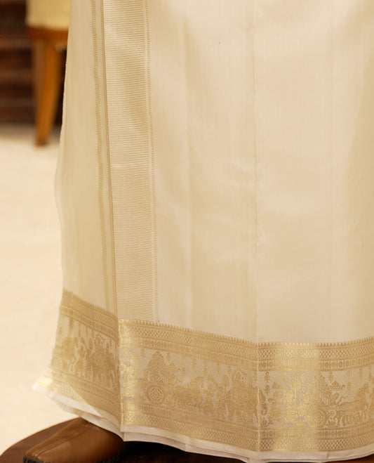 Cream pure silk double-layer dhoti with zari border of rekku, ara maadam, poun and wedding-theme motifs
