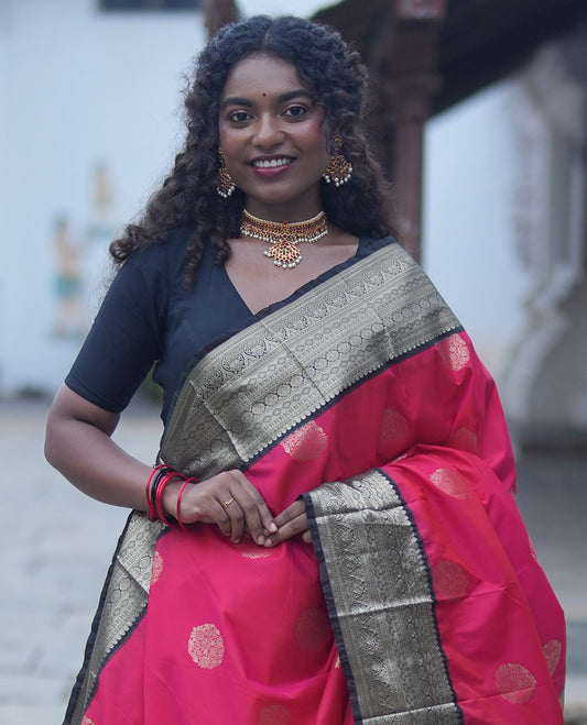 Reddish Orange Budget Silk Saree, Elevated with Floral Zari Buttas All Over Its Body, Complemented by Contrast Traditional Zari Designs Woven Big Border, Grandly Decked Up Pallu, and Paired with a Contrast Blouse