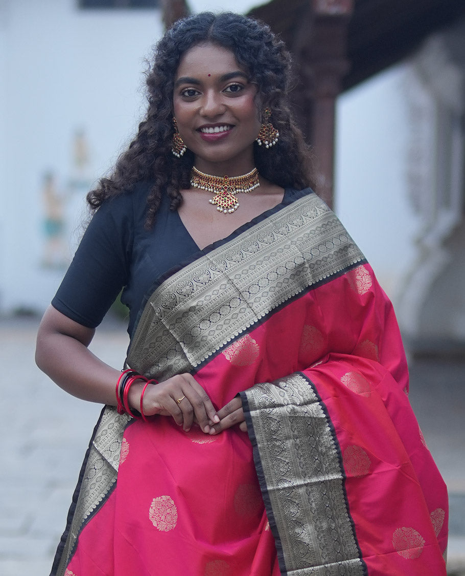Reddish Orange Budget Silk Saree, Elevated with Floral Zari Buttas All Over Its Body, Complemented by Contrast Traditional Zari Designs Woven Big Border, Grandly Decked Up Pallu, and Paired with a Contrast Blouse