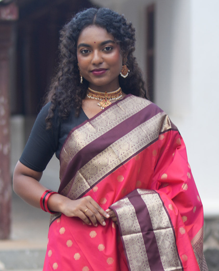 Orange and Brown Budget Silk Saree, Adorned with Zari Buttas All Over Its Body, Complemented by Contrast Rettai Pettu Traditional Zari Border of Jada Nagam, Pallu Steeped with Paisleys, and Paired with a Contrast Blouse